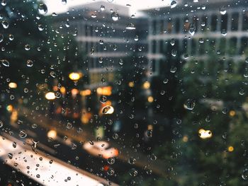 Close-up of wet glass window in rainy season