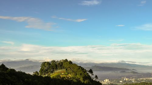 Scenic view of mountains against blue sky