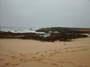 Scenic view of beach against clear sky