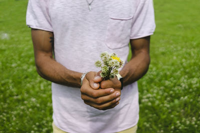 Man holding bunch of flowers in park