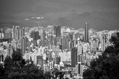 Aerial view of buildings in city against sky