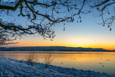 Scenic view of lake against sky during sunset