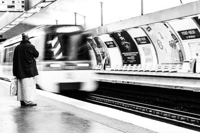 Rear view of a woman at railroad station