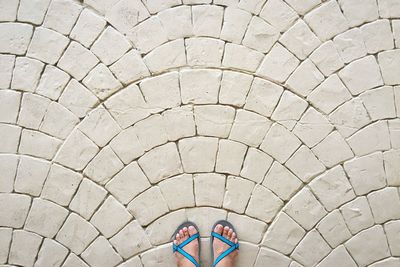 High angle view of feet with blue sandals