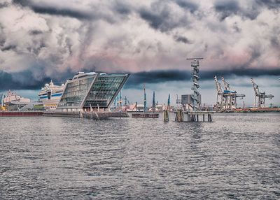 Panoramic view of sea and cityscape against sky