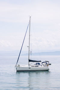 Sailboat sailing on sea against sky