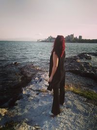 Rear view of woman standing on beach