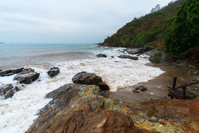 Rocks on beach against sky