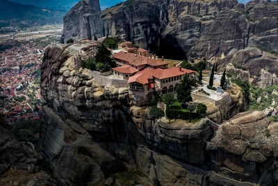 View of temple on rock against buildings