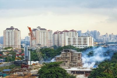 Buildings in city against sky