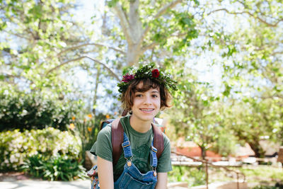 Portrait of a smiling teen with braces wearing a flower crown outside