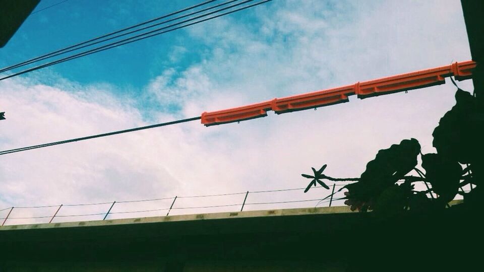 low angle view, sky, power line, built structure, cloud - sky, architecture, cable, cloud, electricity pylon, blue, power supply, connection, electricity, building exterior, pole, cloudy, outdoors, no people, tree, day