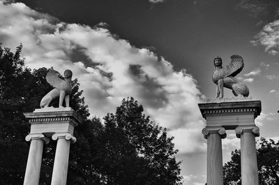 Low angle view of statue against cloudy sky