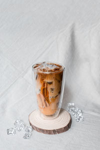 Close-up glass of iced coffee with milk on the table