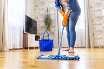 Low section of man cleaning floor