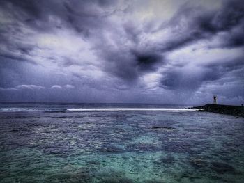 Scenic view of sea against storm clouds