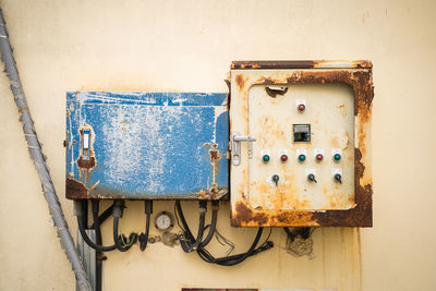 Close-up of old machine panel on the wall