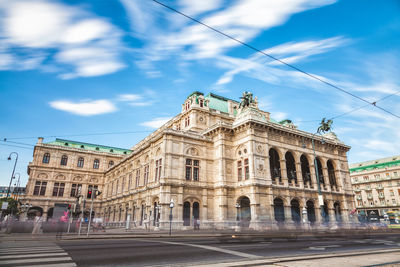 Low angle view of building against cloudy sky