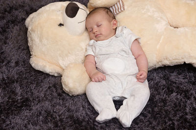 High angle view of cute baby sleeping in toy