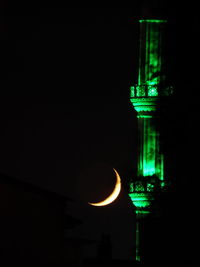 Illuminated building against sky at night