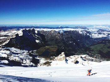 Woman skiing against sky