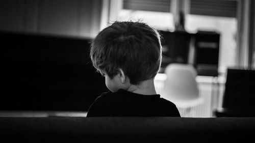 Rear view of boy in living room at home
