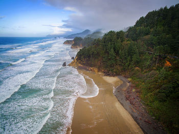 Aerial view of sea against cloudy sky