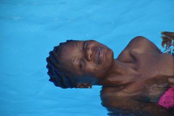 Portrait of young woman swimming in pool