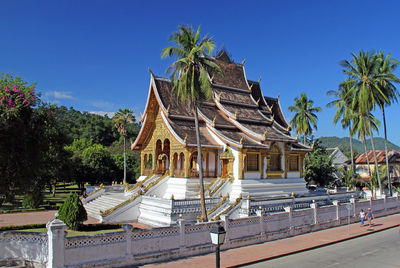 Beautiful temple framed by palm trees under blue sky