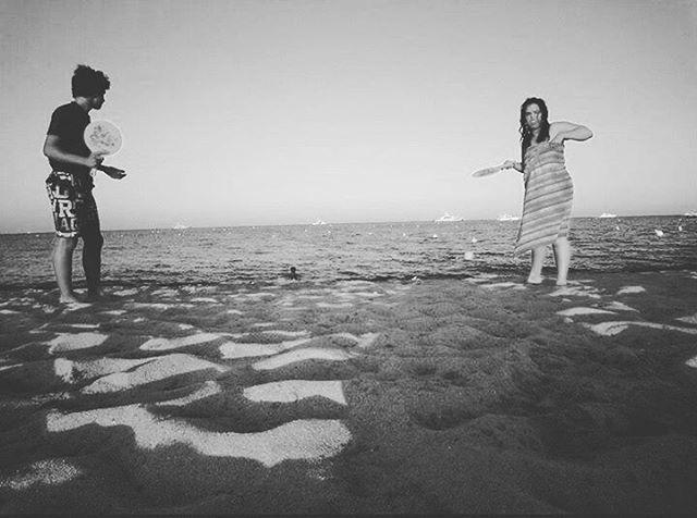 full length, lifestyles, leisure activity, casual clothing, person, childhood, boys, elementary age, young adult, standing, clear sky, sea, copy space, fun, horizon over water, beach, enjoyment