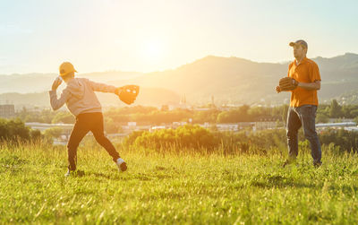 Father and son playing in baseball. man teaching boy baseballs exercise. family sports father's day.