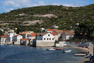 Houses by sea against mountain