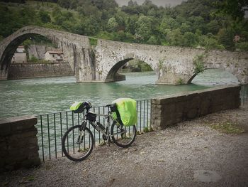 Bicycle by bridge in water