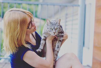 Full length of woman with cat