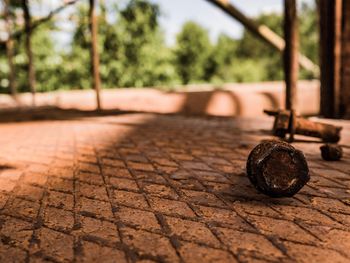 Close-up of rusty metal on footpath