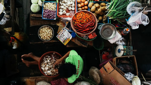 High angle view of woman cleaning garlic