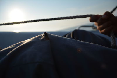 Cropped hand holding rope