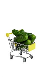 Close-up of green fruits against white background