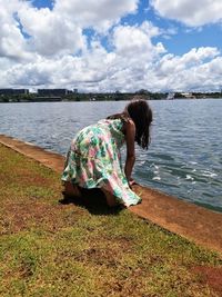 Full length of woman on shore against sky