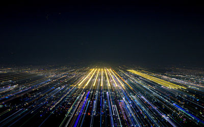 High angle view of light trails on road against sky at night