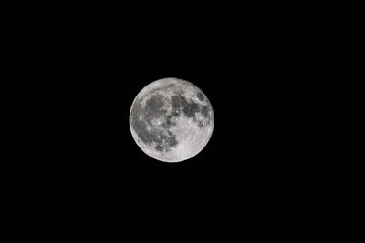 Low angle view of moon against clear sky at night