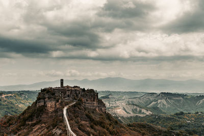 Scenic view of mountain against cloudy sky