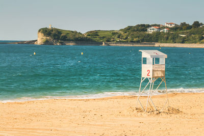 Scenic view of beach and lifeguard hut against sky