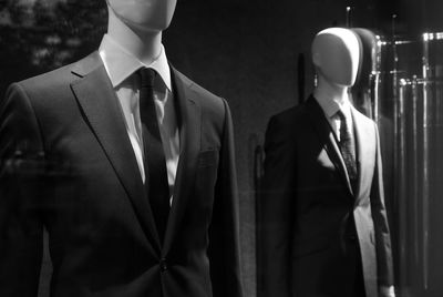 Mannequins with suit at shop window