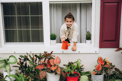 Girl watering plants from a watering can