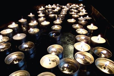 Close-up of lit candle in dark room