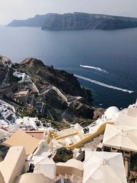 High angle view of townscape by sea against sky