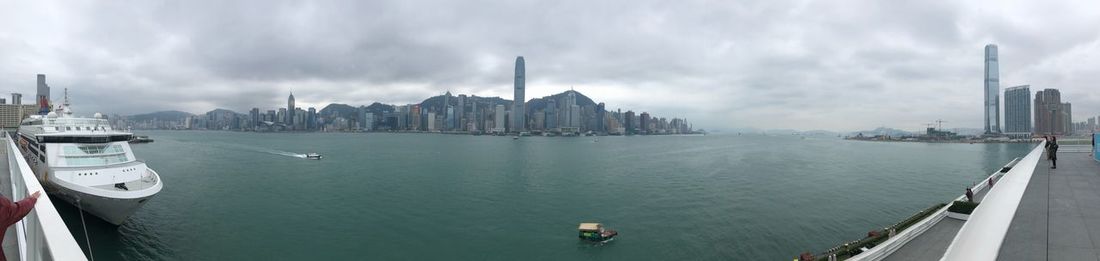 Panoramic view of buildings by sea against sky