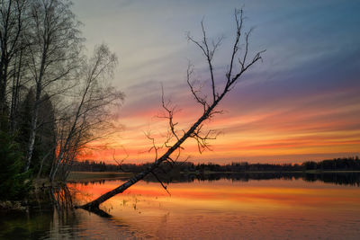 Scenic view of lake against orange sky