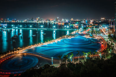 High angle view of illuminated cityscape against sky at night